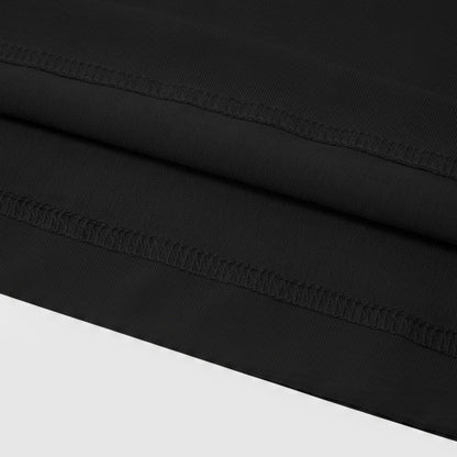 The image is a close-up of a black fabric with a visible sewing detail, such as a seam or stitching, running across the fabric.