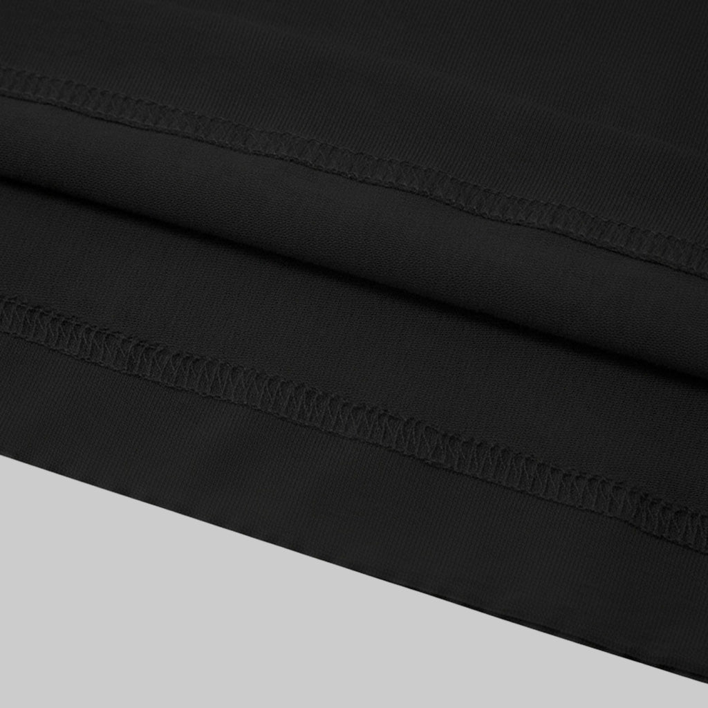 The image is a close-up of a black fabric with a visible sewing detail, such as a seam or stitching, running across the fabric.