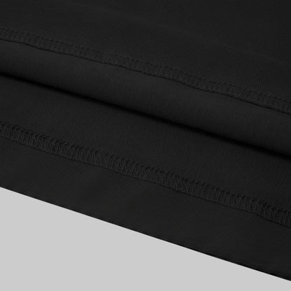 The image is a close-up of a black fabric with a visible sewing detail, such as a seam or stitching, running across the fabric.