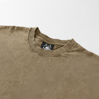 A beige t-shirt with a small black label on the collar.