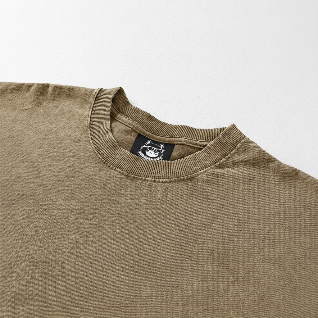 A beige t-shirt with a small black label on the collar.