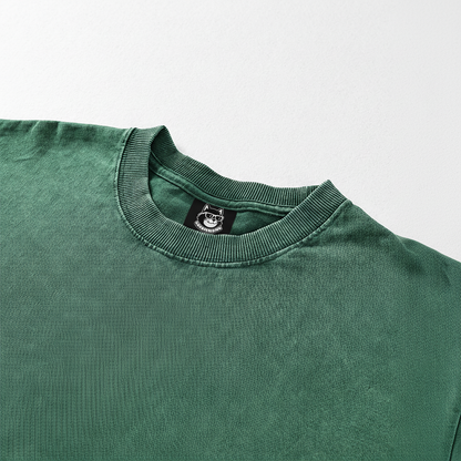 A green t-shirt with a collar and a small label on the collar.
