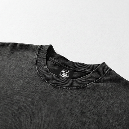 A black t-shirt with a small logo on the collar.