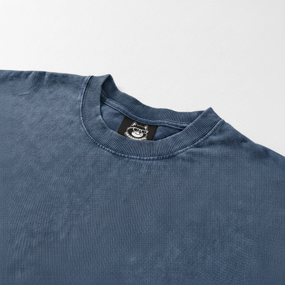 A blue t-shirt with a collar and a small label on the neckline.