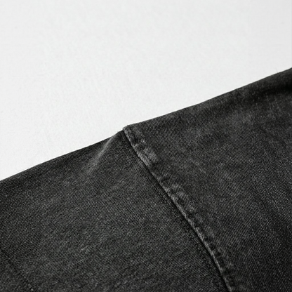 Close-up of black denim fabric on a light gray background