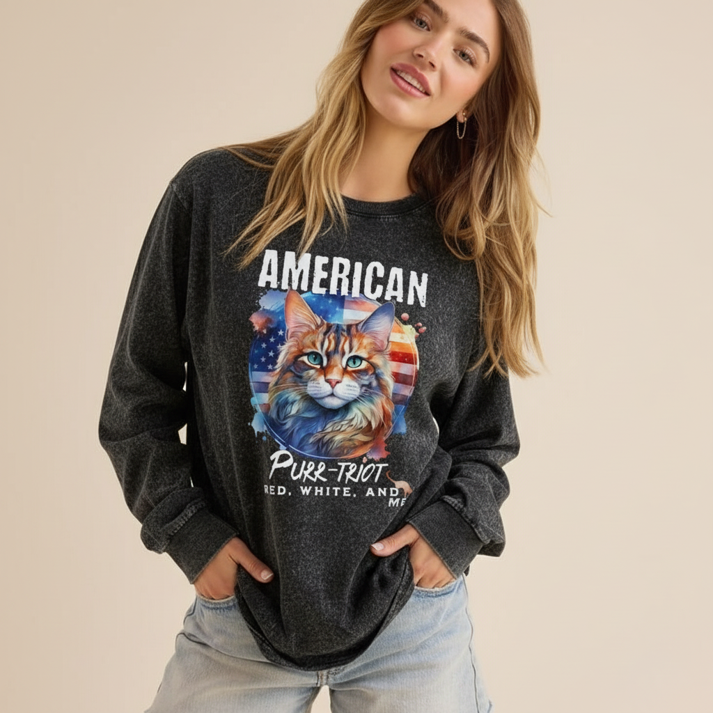 Person wearing a dark gray sweatshirt with a cat graphic and text on a beige background