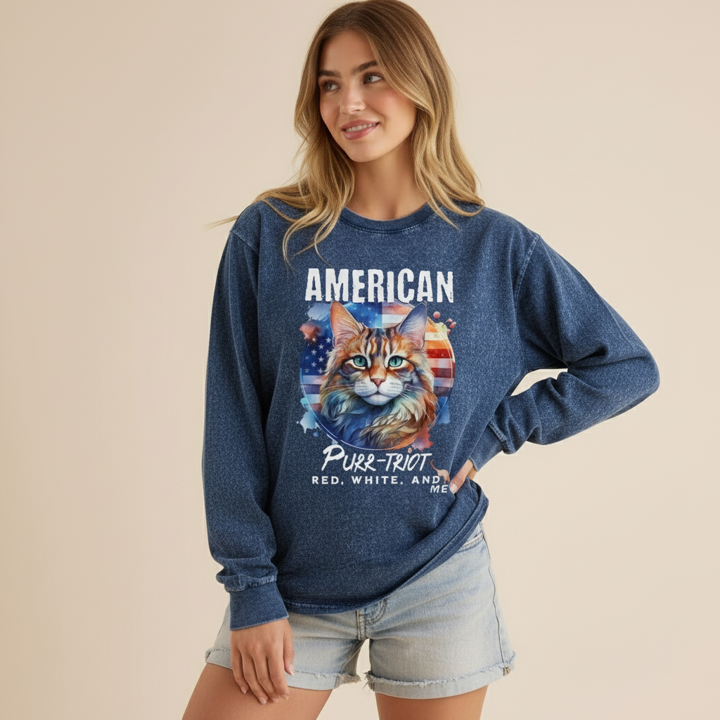 Woman wearing a blue sweatshirt with a cat graphic and text on a beige background