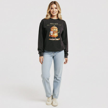 Woman wearing a black sweatshirt with a pumpkin graphic and text on a white background