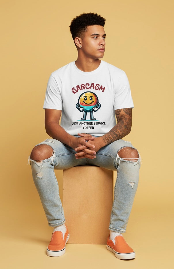 Person wearing a white t-shirt with a graphic design sitting on a beige block.