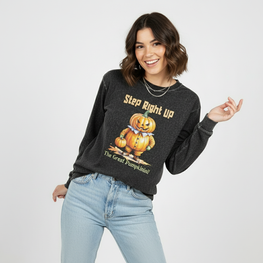 Woman wearing a dark gray sweatshirt with a pumpkin graphic and text, standing against a plain background.