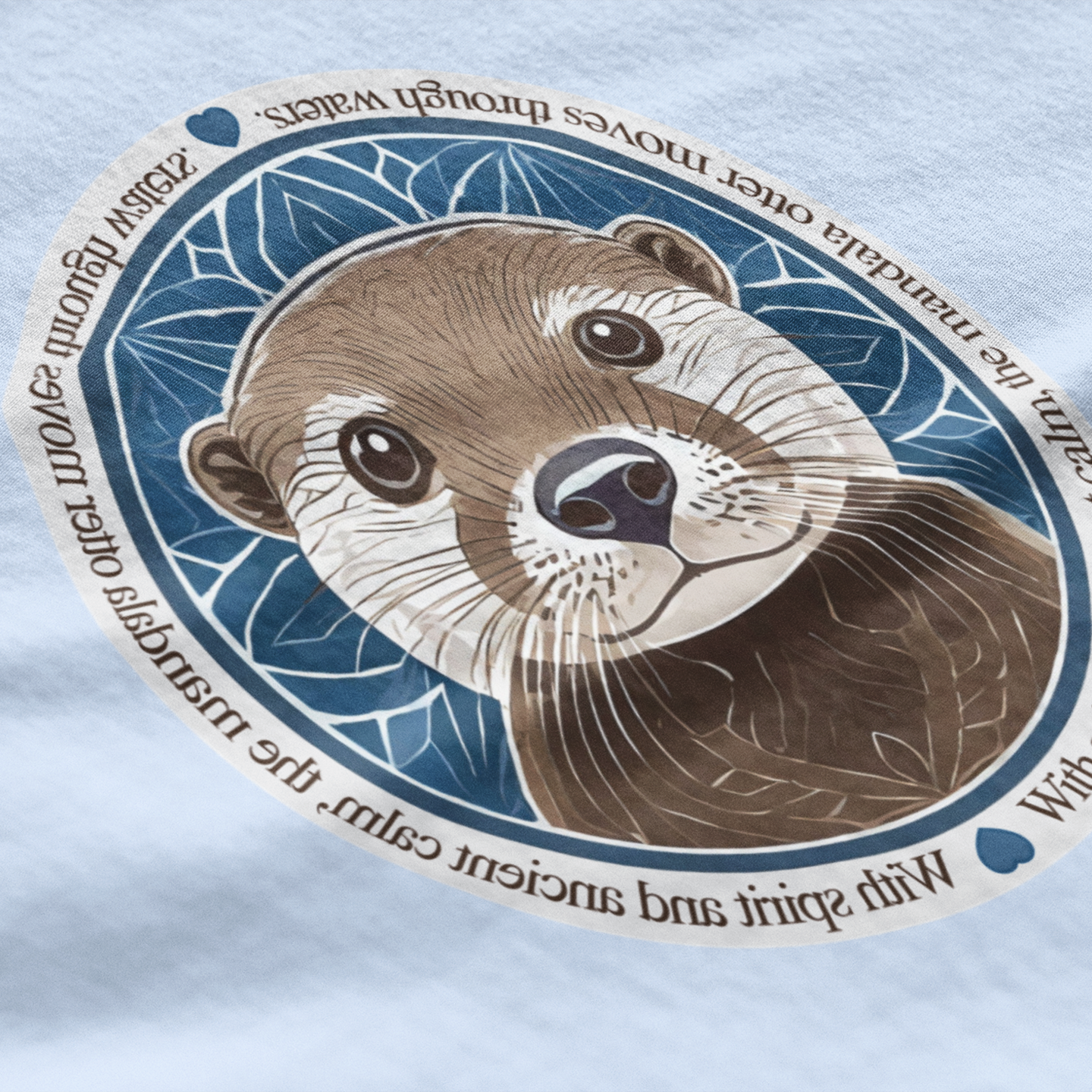 Illustration of an otter's face with decorative elements on a light blue fabric background
