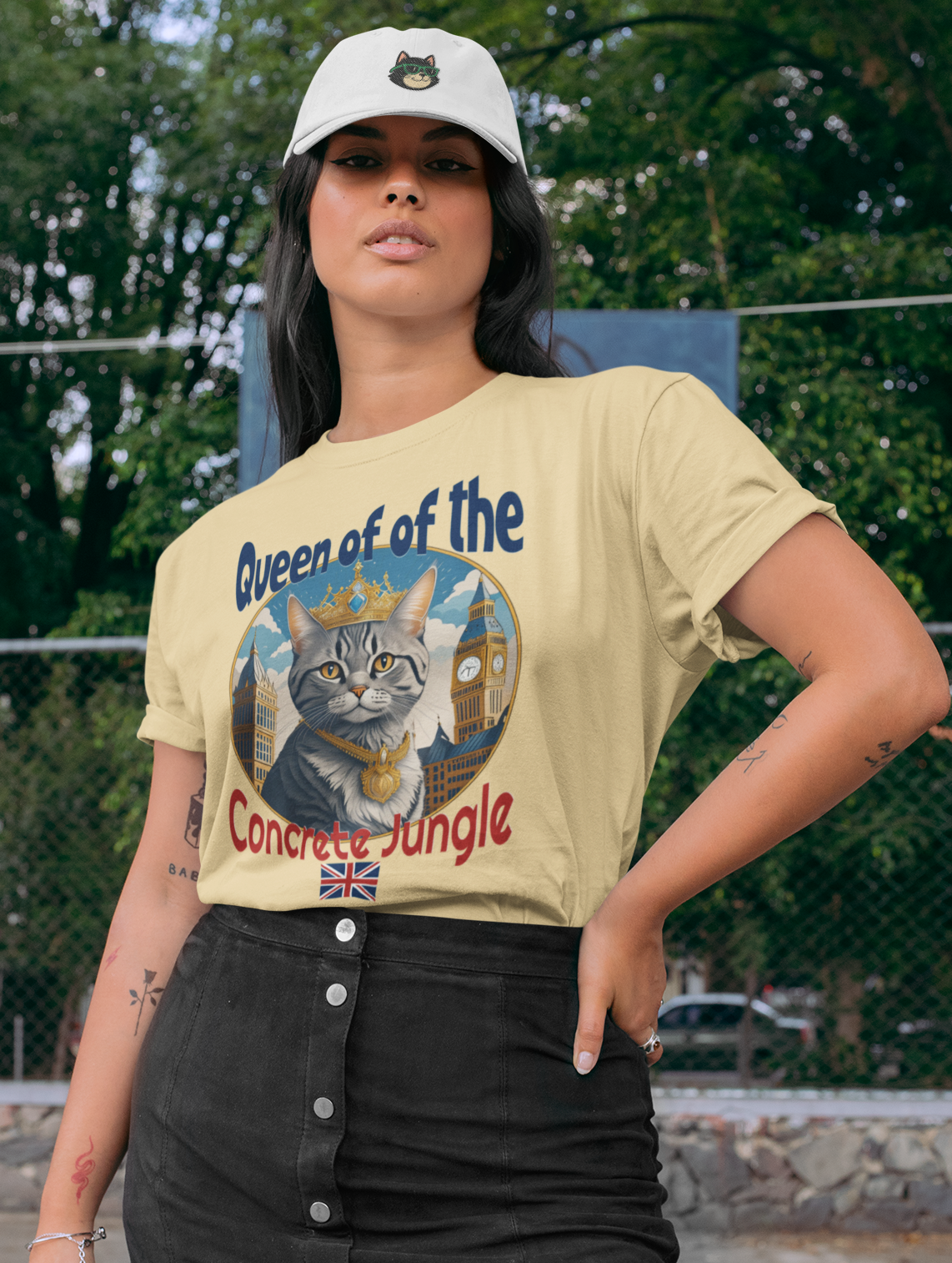 Woman wearing a graphic t-shirt with a cat design and text, standing outdoors.