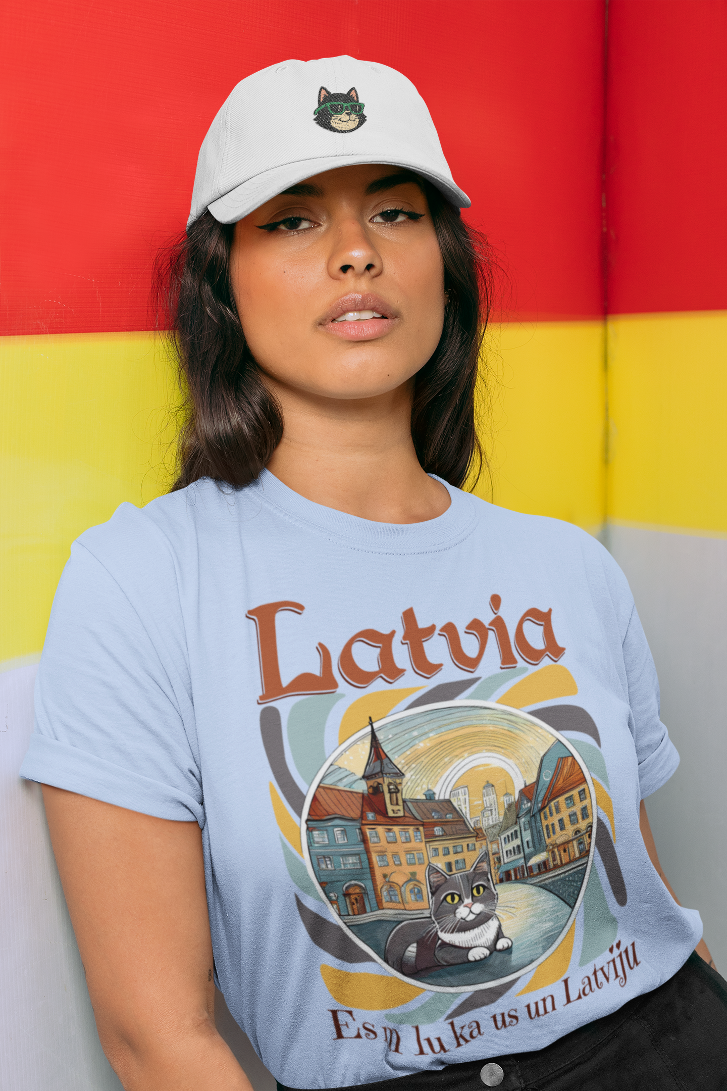 Woman wearing a blue 'Latvia' t-shirt with a cat graphic against a colorful background